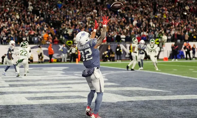 New England Patriots running back TreVeyon Henderson catches a touchdown pass during the second half of an NFL football game against the New York Jets, Thursday, Nov. 13, 2025, in Foxborough, Mass. (AP Photo/Charles Krupa)