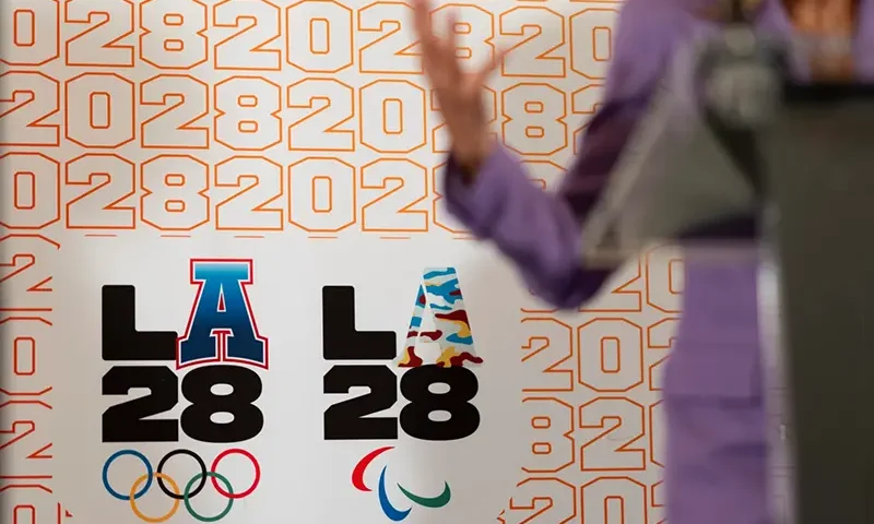 LA28 logos decorate a backdrop a reception to celebrate the upcoming 2028 Olympic Games, to be held in Los Angeles, Saturday, July 27, 2024, in Paris. (AP Photo/David Goldman, File)