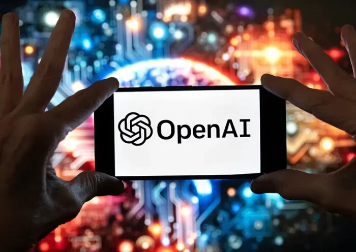 The OpenAI logo is seen displayed on a cell phone in front of an image on a computer screen generated by ChatGPT’s Dall-E text-to-image model, Friday, Dec. 8, 2023, in Boston. (AP Photo/Michael Dwyer, file)