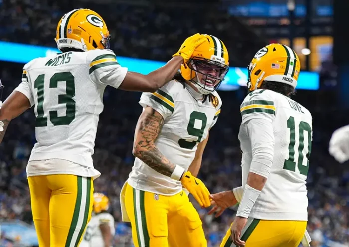 Green Bay Packers wide receiver Christian Watson (9) celebrates a touchdown with wide receiver Dontayvion Wicks (13) and quarterback Jordan Love (10) against the Detroit Lions during the second half an NFL football game in Detroit, Thursday, Nov. 27, 2025. (AP Photo/Ryan Sun)