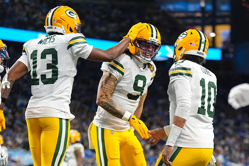 Green Bay Packers wide receiver Christian Watson (9) celebrates a touchdown with wide receiver Dontayvion Wicks (13) and quarterback Jordan Love (10) against the Detroit Lions during the second half an NFL football game in Detroit, Thursday, Nov. 27, 2025. (AP Photo/Ryan Sun)