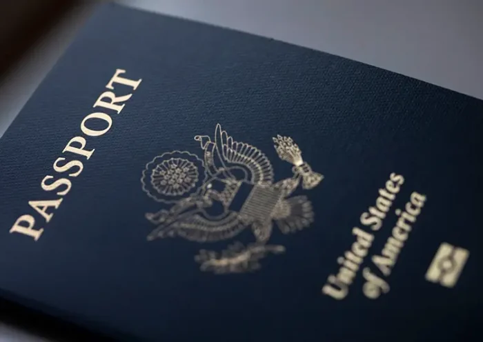 The cover of a U.S. Passport is displayed in Tigard, Ore., Saturday, Dec. 11, 2021. (AP Photo/Jenny Kane, File)