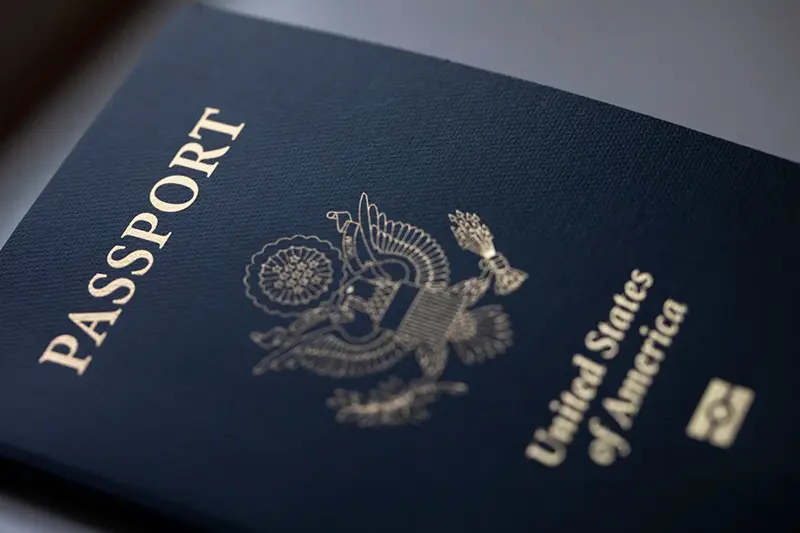 The cover of a U.S. Passport is displayed in Tigard, Ore., Saturday, Dec. 11, 2021. (AP Photo/Jenny Kane, File)