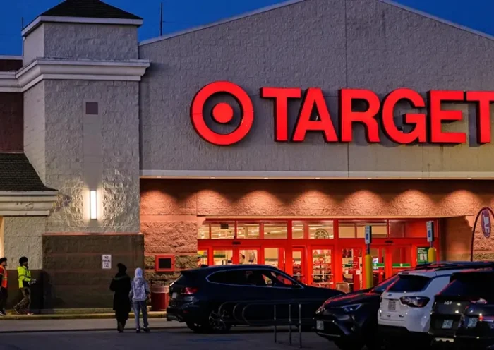 Shoppers walk towards a Target retail store, Tuesday, Nov. 18, 2025, in Salem, N.H. (AP Photo/Charles Krupa)