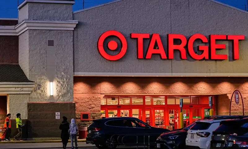 Shoppers walk towards a Target retail store, Tuesday, Nov. 18, 2025, in Salem, N.H. (AP Photo/Charles Krupa)