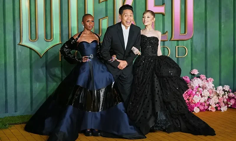 Cynthia Erivo, from left, director Jon M. Chu and Ariana Grande pose for photographers upon arrival at the premiere of the film “Wicked For Good” in London, Monday, Nov. 10, 2025. (Photo by Scott A Garfitt/Invision/AP)