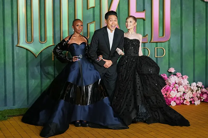 Cynthia Erivo, from left, director Jon M. Chu and Ariana Grande pose for photographers upon arrival at the premiere of the film “Wicked For Good” in London, Monday, Nov. 10, 2025. (Photo by Scott A Garfitt/Invision/AP)