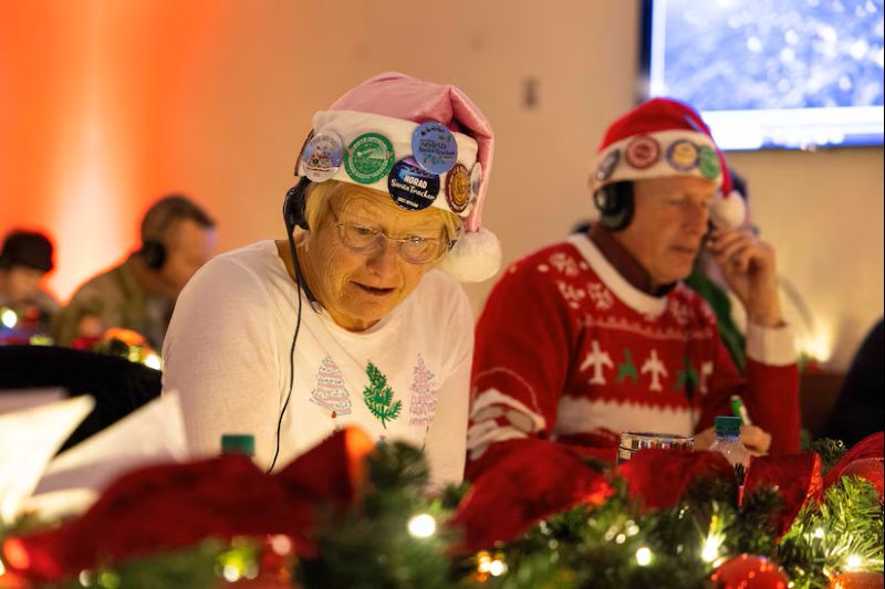 Volunteers take phone calls for the NORAD Santa Tracker (Photo via: U.S. Department of War)