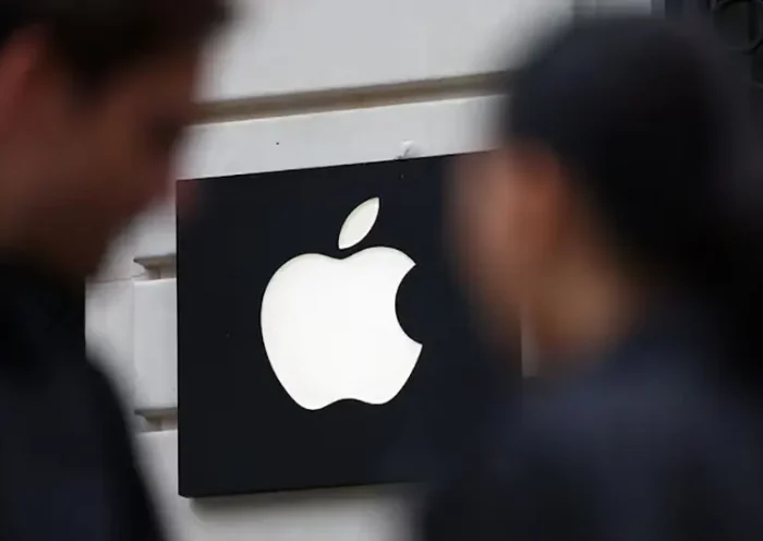 People walk past an Apple logo at an Apple store in Paris, France, April 23, 2025. REUTERS/Abdul Saboor