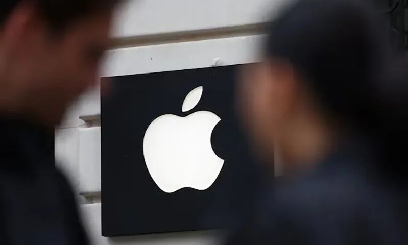 People walk past an Apple logo at an Apple store in Paris, France, April 23, 2025. REUTERS/Abdul Saboor