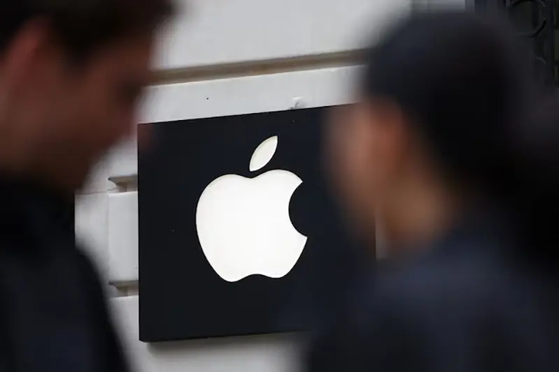 People walk past an Apple logo at an Apple store in Paris, France, April 23, 2025. REUTERS/Abdul Saboor
