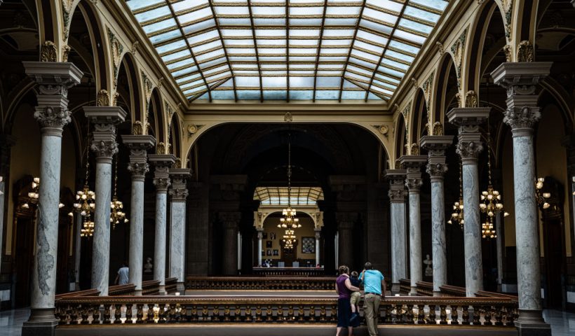 INDIANAPOLIS, IN - JULY 25: A family watches protesters from the top floor of the Indiana State Capitol building on July 25, 2022 in Indianapolis, Indiana. Activists are gathering during a special session of the Indiana state Senate concerning abortion access in the state. (Photo by Jon Cherry/Getty Images)