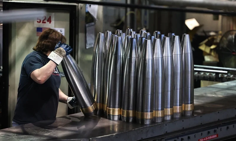 TOPSHOT - An employee handles 155 mm caliber shells after the manufacturing process at the Scranton Army Ammunition Plant (SCAAP) in Scranton, Pennsylvania on April 16, 2024. In brick buildings that are more than a century old, nearly in the heart of Joe Biden's Rust Belt hometown of Scranton, Pennsylvania, dated machinery churns artillery for modern conflicts, especially the war in Ukraine. The Scranton Army Ammunition Plant (SCAAP) is making steel tubes for 155 mm caliber shells, which are crucial to Kyiv's efforts to face down Moscow's invasion. (Photo by Charly TRIBALLEAU / AFP) (Photo by CHARLY TRIBALLEAU/AFP via Getty Images)