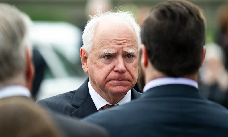 MINNEAPOLIS, MINNESOTA - JUNE 28: Minnesota Gov. Tim Walz presents a Minnesota flag to the family of DFL Rep. Melissa Hortman and her husband Mark Hortman after a funeral ceremony at the Basilica of Saint Mary on June 28, 2025 in Minneapolis, Minnesota. Law enforcement agencies captured Vance Boelter on June 15th in connection with the killing of Rep. Hortman and her husband, Mark, who were shot at their home on June 14th. DFL State Sen. John Hoffman and his wife were also shot and hospitalized in a separate incident. Minnesota Gov. Tim Walz said during a press conference that the shooting "appears to be a politically motivated assassination." (Photo by Stephen Maturen/Getty Images)