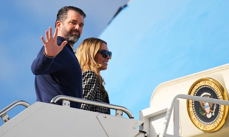 LOSSIEMOUTH, SCOTLAND - JULY 29: Donald Trump Jr. with partner Bettina Anderson prepare to board Air Force One at RAF Lossiemouth, on July 29, 2025 in Lossiemouth, Scotland. President Trump visited Scotland on a trip that was part-vacation, part-work, as he stayed at his Trump Turnberry golf course, followed by the Trump International Golf Links in Aberdeenshire, between July 25 to 29. (Photo by Andrew Harnik/Getty Images)
