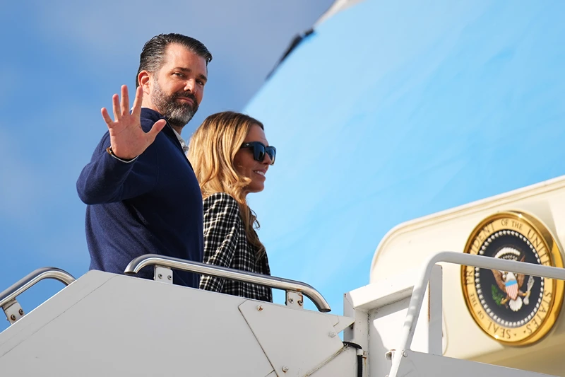 LOSSIEMOUTH, SCOTLAND - JULY 29: Donald Trump Jr. with partner Bettina Anderson prepare to board Air Force One at RAF Lossiemouth, on July 29, 2025 in Lossiemouth, Scotland. President Trump visited Scotland on a trip that was part-vacation, part-work, as he stayed at his Trump Turnberry golf course, followed by the Trump International Golf Links in Aberdeenshire, between July 25 to 29. (Photo by Andrew Harnik/Getty Images)