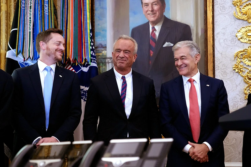 WASHINGTON, DC - NOVEMBER 06: Director of Medicare and Deputy Administrator of CMS Chris Comp (L), Health and Human Services Secretary Robert F. Kennedy Jr., and Administrator for the Centers for Medicare & Medicaid Services Dr. Mehmet Oz stand together while President Donald Trump delivers remarks on lowering drug prices in the Oval Office at the White House on November 06, 2025 in Washington, DC. Trump announced that his administration has reached agreements with drugmakers Eli Lilly and Novo Nordisk that would lower the price of some GLP-1 weight loss medications. (Photo by Andrew Harnik/Getty Images)