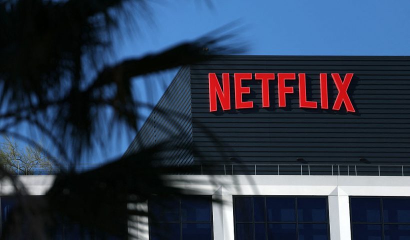 The Netflix logo is pictured at the company's Hollywood studio offices at Sunset Bronson Studios in Los Angeles, California on December 5, 2025. Streaming giant Netflix said December 5, 2025 it will buy film and television studio Warner Bros. Discovery for nearly $83 billion, the entertainment industry's biggest consolidation deal this decade. The acquisition gives Netflix access to a vast film catalog as well as the prestigious streaming service HBO Max. (Photo by Patrick T. Fallon / AFP via Getty Images)