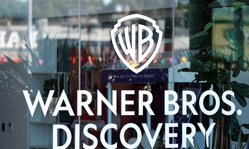 The logo of Warner Bros. Discovery is seen at one of their offices in Culver City, California, on December 5, 2025. (Photo by Patrick T. Fallon / AFP via Getty Images)