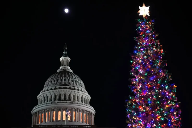 WASHINGTON, DC - DECEMBER 02: The moon rises over the U.S. Capitol and U.S. Capitol Christmas Tree during a Christmas Tree lighting ceremony on the West Front Lawn at the U.S. Capitol on December 02, 2025 in Washington, DC. This year’s tree, a 53-foot red fir from the Humboldt-Toiyabe National Forest, marks the first U.S. Capitol Christmas Tree from the state of Nevada. (Photo by Andrew Harnik/Getty Images)