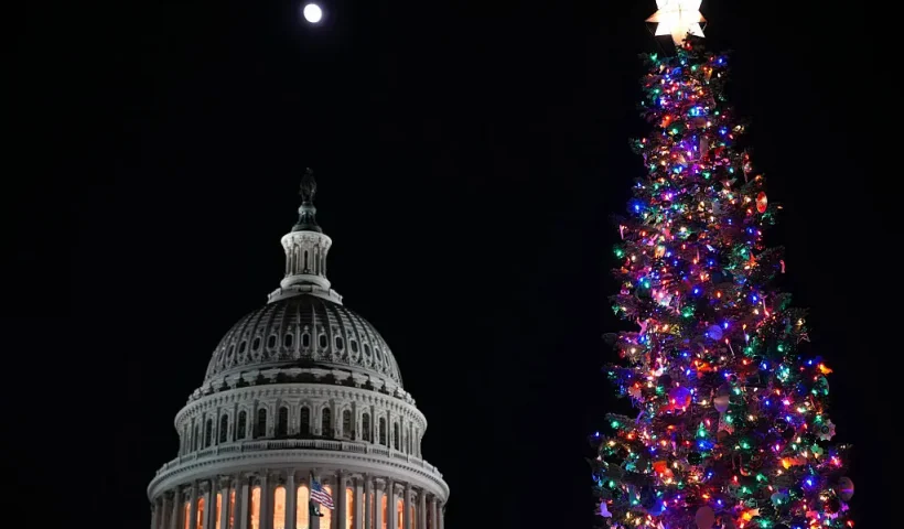 WASHINGTON, DC - DECEMBER 02: The moon rises over the U.S. Capitol and U.S. Capitol Christmas Tree during a Christmas Tree lighting ceremony on the West Front Lawn at the U.S. Capitol on December 02, 2025 in Washington, DC. This year’s tree, a 53-foot red fir from the Humboldt-Toiyabe National Forest, marks the first U.S. Capitol Christmas Tree from the state of Nevada. (Photo by Andrew Harnik/Getty Images)