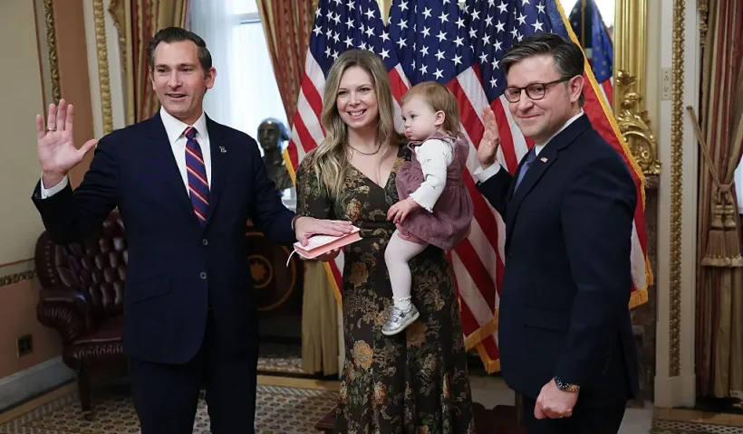 WASHINGTON, DC - DECEMBER 04: Rep. Matt Van Epps (L) (R-TN) participates in a ceremonial swearing-in with Speaker of the House Mike Johnson (R) (R-LA) December 4, 2025 in Washington, DC. Also pictured holding the Bible is Van Epps' wife, Meg Wrather, and their daughter, Amelia Van Epps. (Photo by Win McNamee/Getty Images)