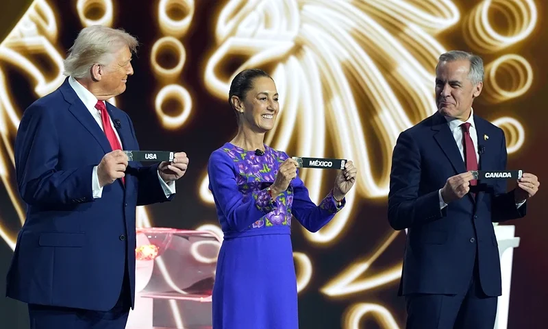 WASHINGTON, DC - DECEMBER 05: U.S. President Donald Trump, Claudia Sheinbaum, President of Mexico, and Mark Carney, Prime Minister of Canada, show the draw on stage during the FIFA World Cup 2026 Official Draw at John F. Kennedy Center for the Performing Arts on December 05, 2025 in Washington, DC. (Photo by Stephanie Scarbrough - Pool/Getty Images)