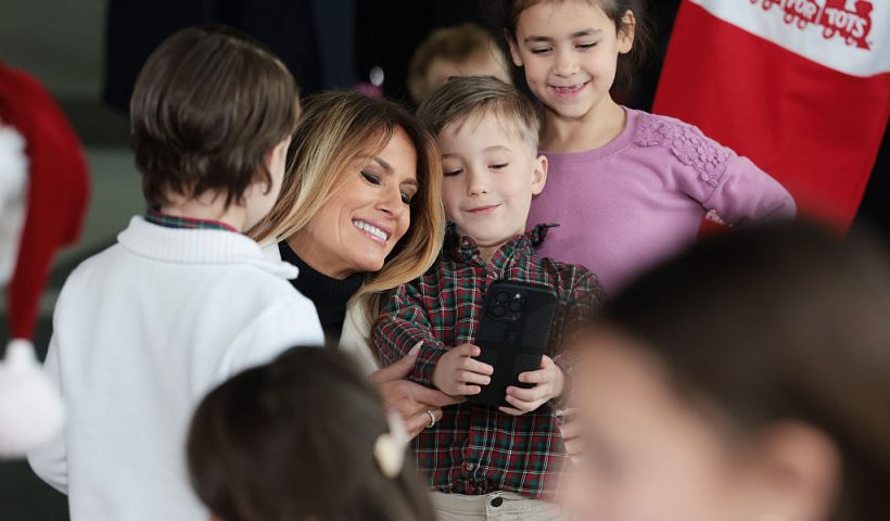 QUANTICO, VIRGINIA - DECEMBER 08: First lady Melania Trump takes photos with children of service members during a Toys for Tots Charity Drive at Marine Corps Base Quantico on December 08, 2025 in Quantico, Virginia. Mrs. Trump delivered remarks to military families and helped children make Christmas cards and sort toys. (Photo by Anna Moneymaker/Getty Images)