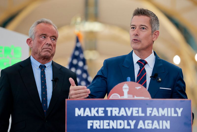 ARLINGTON, VA - DECEMBER 08: U.S. Transportation Secretary Sean P. Duffy (R) speaks alongside Human Services Secretary Robert F. Kennedy Jr. at a conference discussing the launch of the "Make Travel Family Friendly Again" campaign at Ronald Reagan Washington National Airport on December 08, 2025 in Arlington, Virginia. The campaign's focus is to incentivize family-friendly resources at airports. (Photo by Heather Diehl/Getty Images)
