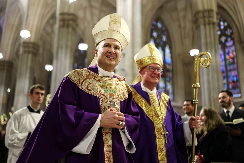 Cardinal Timothy Dolan (R) and his successor Ronald Hicks arrive to lead a mass at St. Patrick's Cathedral in the Manhattan borough of New York City on December 18, 2025. Pope Leo XIV has accepted the resignation of New York's conservative Archbishop Timothy Dolan and named a little-known, pro-migrant bishop from his native Chicago to replace him, the Vatican said on December 18. (Photo by CHARLY TRIBALLEAU / AFP via Getty Images)