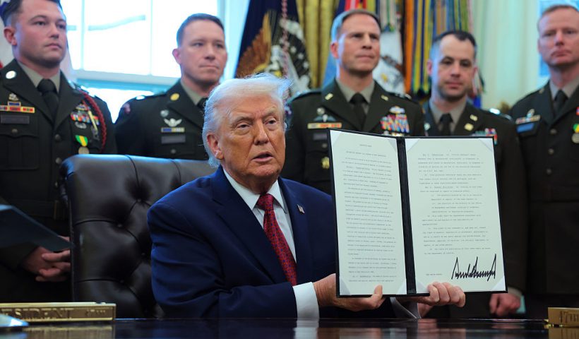 WASHINGTON, DC - DECEMBER 15: U.S. President Donald Trump poses with a recently signed executive order classifying fentanyl as a "weapon of mass destruction," during a ceremony for the presentation of the Mexican Border Defense Medal in the Oval Office of the White House on December 15, 2025 in Washington, DC. During the ceremony, Trump recognized the first 13 service members to receive the recently established Mexican Border Defense Medal (MBDM), which recognizes service members supporting Customs and Border Protection on the U.S.-Mexico border. (Photo by Anna Moneymaker/Getty Images)
