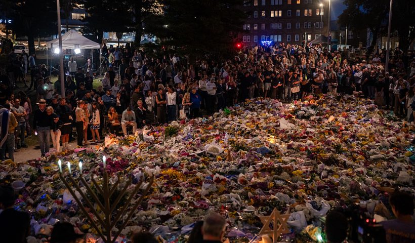 SYDNEY, AUSTRALIA - DECEMBER 16: Floral tributes and candles are placed at at Bondi Pavilion at Bondi Beach on December 16, 2025 in Sydney, Australia. Police say at least 15 people and one suspected gunman were killed and more than a dozen others injured when two attackers opened fire near a Hanukkah celebration at the world-famous Bondi Beach, in what authorities have declared a terrorist incident. The government is moving to tighten gun laws across the country. (Photo by Audrey Richardson/Getty Images)