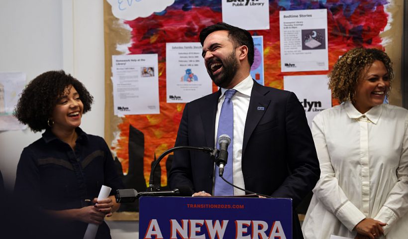 NEW YORK, NEW YORK - DECEMBER 17: Mayor-elect Zohran Mamdani speaks to members of the media at a Brooklyn library to make a transition announcement for his administration on December 17, 2025 in New York City. Jahmila Edwards (right) will be the head of the Mayor's Office of Intergovernmental Relations and Cat Da Costa (left) will become the head of the Mayor's Office of Appointments. Upon taking office, the incoming administration will seek to address a $380 million budget deficit. (Photo by Spencer Platt/Getty Images)