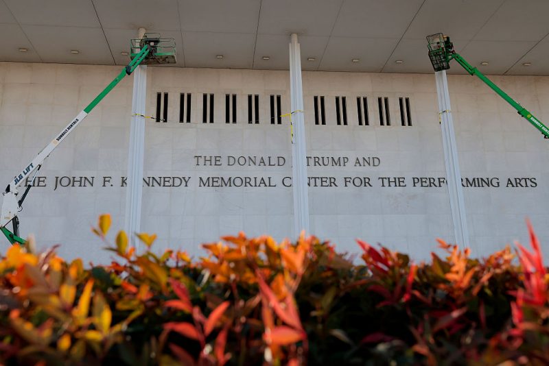 WASHINGTON, DC - DECEMBER 19: Workers adjust the name of the “John F. Kennedy Memorial Center for the Performing Arts" on December 19, 2025 in Washington, DC. The Kennedy Center Board of Trustees voted in what they say was a unanimous decision to rename the facility “The Donald J. Trump and The John F. Kennedy Memorial Center for the Performing Arts”. (Photo by Heather Diehl/Getty Images)