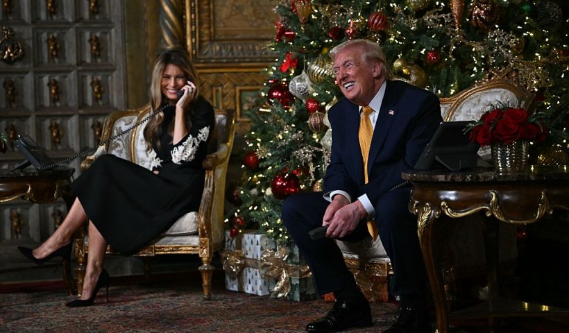 US President Donald Trump and first lady Melania Trump participate in NORAD Santa tracker phone calls, on Christmas Eve, from the Mar-a-lago club in Palm Beach, Florida, on December 24, 2025. (Photo by ANDREW CABALLERO-REYNOLDS / AFP via Getty Images)