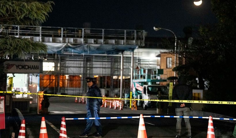 A police officer stands guard inside the cordon at the Yokohama Rubber Mishima Plant in Mishima, Shizuoka Prefecture on December 26, 2025. Fifteen people were injured in a stabbing attack in a rubber factory in central Japan on December 26, during which an unspecified liquid was also sprayed, emergency officials said. (Photo by Yuichi YAMAZAKI / AFP via Getty Images)