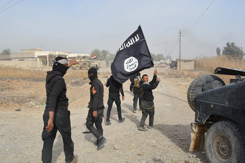 TOPSHOT - Iraqi government forces celebrate while holding an Islamis Sate (IS) group flag after they claimed they have gained complete control of the Diyala province, northeast of Baghdad, on January 26, 2015 near the town of Muqdadiyah. Iraqi forces have "liberated" Diyala province from the Islamic State jihadist group, retaking all populated areas of the eastern region, a top army officer said today. The symbolic victory for Baghdad, which has at times struggled to push IS back, could clear the way for further advances against the jihadists . AFP PHOTO / YOUNIS AL-BAYATI (Photo by YOUNIS AL-BAYATI / AFP) (Photo by YOUNIS AL-BAYATI/AFP via Getty Images)