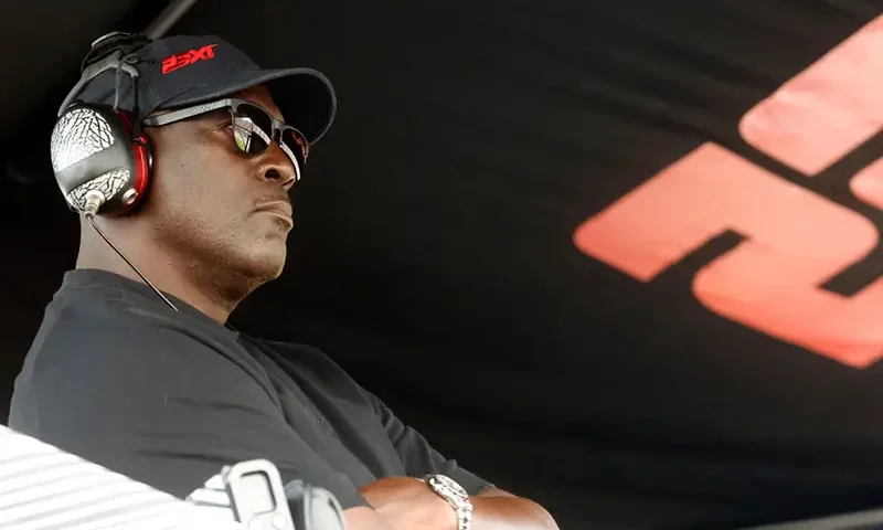 Michael Jordan, co-owner of 23XI Racing, sits in his pit box during a NASCAR Cup Series auto race at Talladega Superspeedway, Sunday, Oct. 6, 2024, in Talladega, Ala. (AP Photo/ Butch Dill, File)