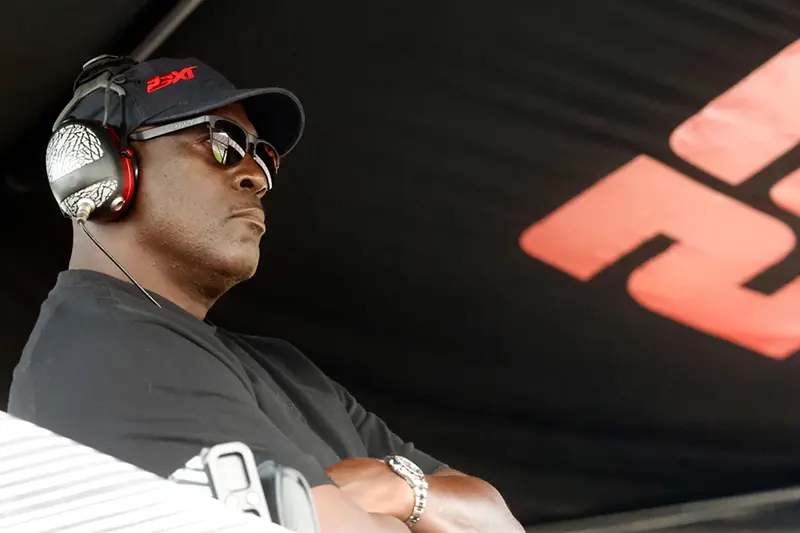 Michael Jordan, co-owner of 23XI Racing, sits in his pit box during a NASCAR Cup Series auto race at Talladega Superspeedway, Sunday, Oct. 6, 2024, in Talladega, Ala. (AP Photo/ Butch Dill, File)