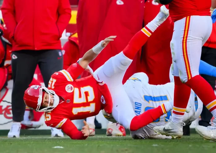 Kansas City Chiefs quarterback Patrick Mahomes (15) is injured after being tackled by Los Angeles Chargers defensive tackle Da’Shawn Hand (91) during the second half of an NFL football game, Sunday, Dec. 14, 2025 in Kansas City, Mo. (AP Photo/Reed Hoffmann)