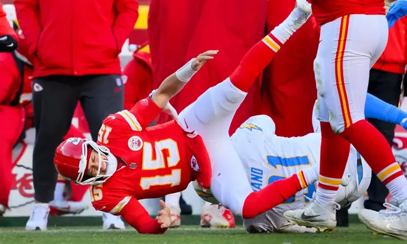 Kansas City Chiefs quarterback Patrick Mahomes (15) is injured after being tackled by Los Angeles Chargers defensive tackle Da’Shawn Hand (91) during the second half of an NFL football game, Sunday, Dec. 14, 2025 in Kansas City, Mo. (AP Photo/Reed Hoffmann)