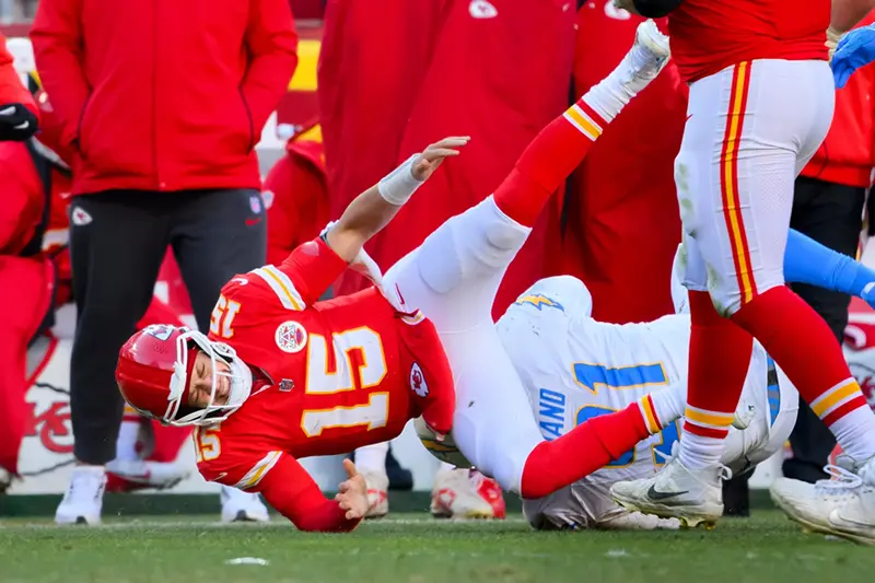Kansas City Chiefs quarterback Patrick Mahomes (15) is injured after being tackled by Los Angeles Chargers defensive tackle Da’Shawn Hand (91) during the second half of an NFL football game, Sunday, Dec. 14, 2025 in Kansas City, Mo. (AP Photo/Reed Hoffmann)
