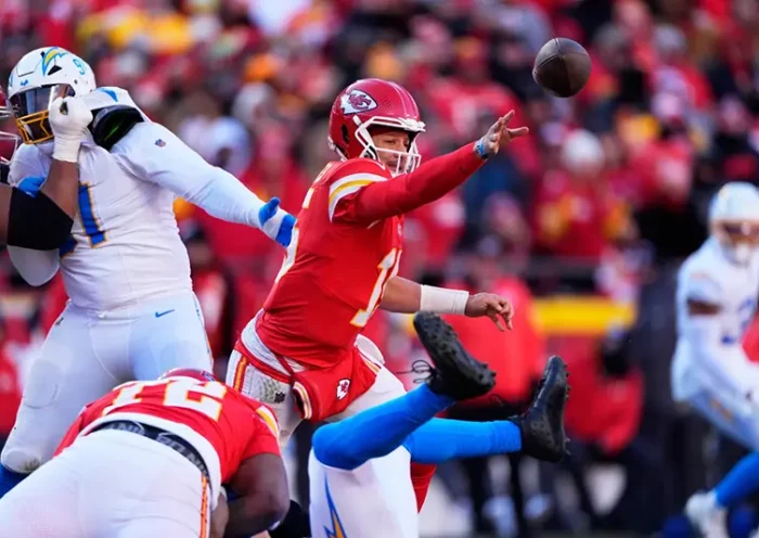 Kansas City Chiefs quarterback Patrick Mahomes (15) gets rid of the ball during the second half of an NFL football game against the Los Angeles Chargers Sunday, Dec. 14, 2025, in Kansas City, Mo. (AP Photo/Charlie Riedel)