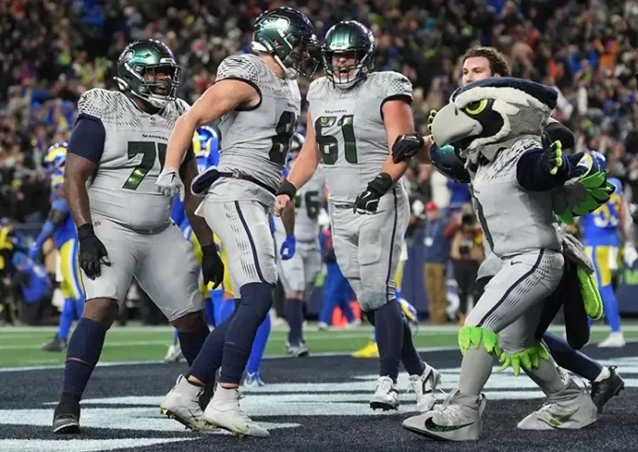 Seattle Seahawks tight end Eric Saubert, second from left, celebrates after making a two-point conversion during overtime in an NFL football game against the Los Angeles Rams, Thursday, Dec. 18, 2025, in Seattle. (AP Photo/Lindsey Wasson)