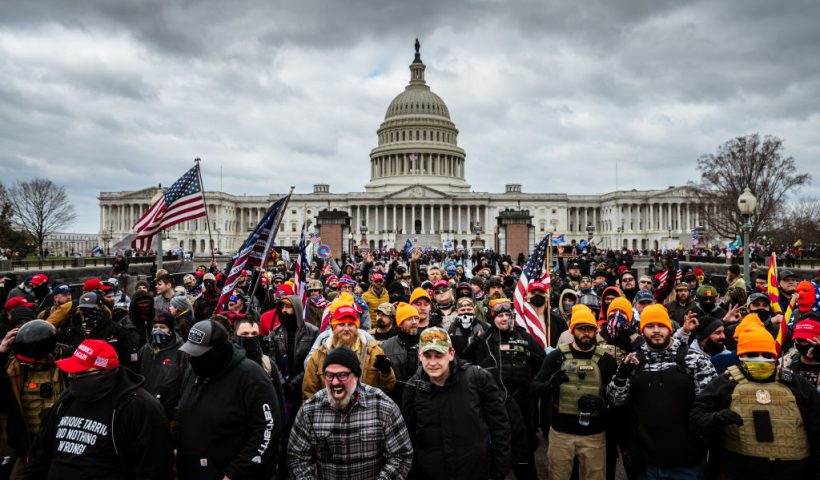 WASHINGTON, DC - JANUARY 06: Pro-Trump protesters, including Proud Boys leader Joe Biggs, (plaid shirt at bottom center of frame,) gather in front of the U.S. Capitol Building on January 6, 2021 in Washington, DC. A pro-Trump mob stormed the Capitol, breaking windows and clashing with police officers. Trump supporters gathered in the nation's capital today to protest the ratification of President-elect Joe Biden's Electoral College victory over President Trump in the 2020 election. (Photo by Jon Cherry/Getty Images)