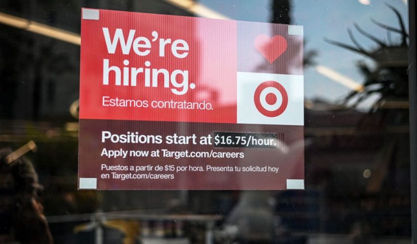 A sign advertising for new employees with an updated starting salary of USD $16.75 per hour is seen in the window of a Target store in Hollywood, California on November 9, 2021. - Even as millions of Americans who lost their jobs to the Covid-19 pandemic have returned to work, companies nationwide report they're still struggling to hire employees in recent months. More than 10 million jobs were unfilled as of the end of August, according to government data. (Photo by Robyn Beck / AFP) (Photo by ROBYN BECK/AFP via Getty Images)