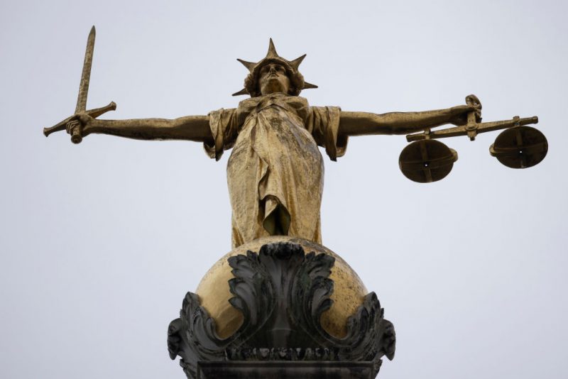 LONDON, ENGLAND - JANUARY 19: A statue of the Scales of Justice stands above the Old Bailey on January 19, 2021 in London, England. Criminal watchdogs representing England and Wales have expressed concern over the backlog of cases, caused by the Coronavirus pandemic. Figures have revealed that the backlog of unheard cases in the crown courts has reached 54,000. (Photo by Dan Kitwood/Getty Images)