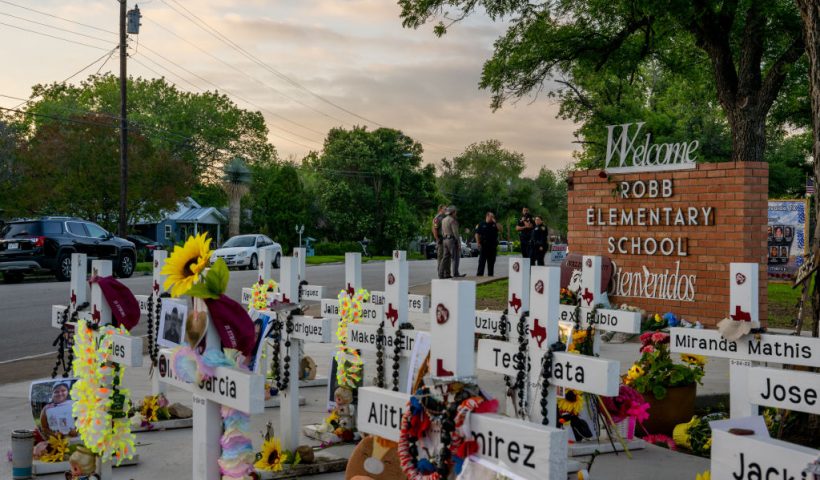 UVALDE, TEXAS - MAY 24: Law enforcement stand watch near a memorial dedicated to the 19 children and two adults murdered on May 24, 2022 during the mass shooting at Robb Elementary School on May 24, 2023 in Uvalde, Texas. Today marks the 1-year anniversary of the mass shooting at the school. 19 children and two teachers were killed when a gunman entered the school, opening fire on students and faculty. (Photo by Brandon Bell/Getty Images)