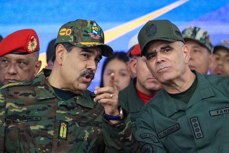 CARACAS, VENEZUELA - NOVEMBER 25: President of Venezuela Nicolás Maduro talks with Minister of Defense Vladimir Padrino Lopez during a military ceremony commemorating the 200th anniversary of the presentation of the 'Sword of Peru' to Venezuelan independence hero Simón Bolívar on November 25, 2025, in Caracas, Venezuela. The United States recently designated the "Cartel De Los Soles" (Cartel of The Suns) as a foreign terrorist organization, a group allegedly led by the president of Venezuela, Nicolas Maduro, and which, it is presumed, includes high-ranking members of the Venezuelan government. (Photo by Jesus Vargas/Getty Images)