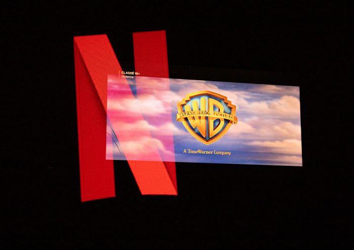 Double exposure photograph of the Netflix logo and the Warner Bros logo on a television screen at Kerlouan in Brittany in France on December 05 2025. (Photo by Vincent Feuray / Hans Lucas / AFP via Getty Images)